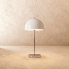 Clérachic table lamp in chrome, its glossy white dome shade set atop a slim polished stem.