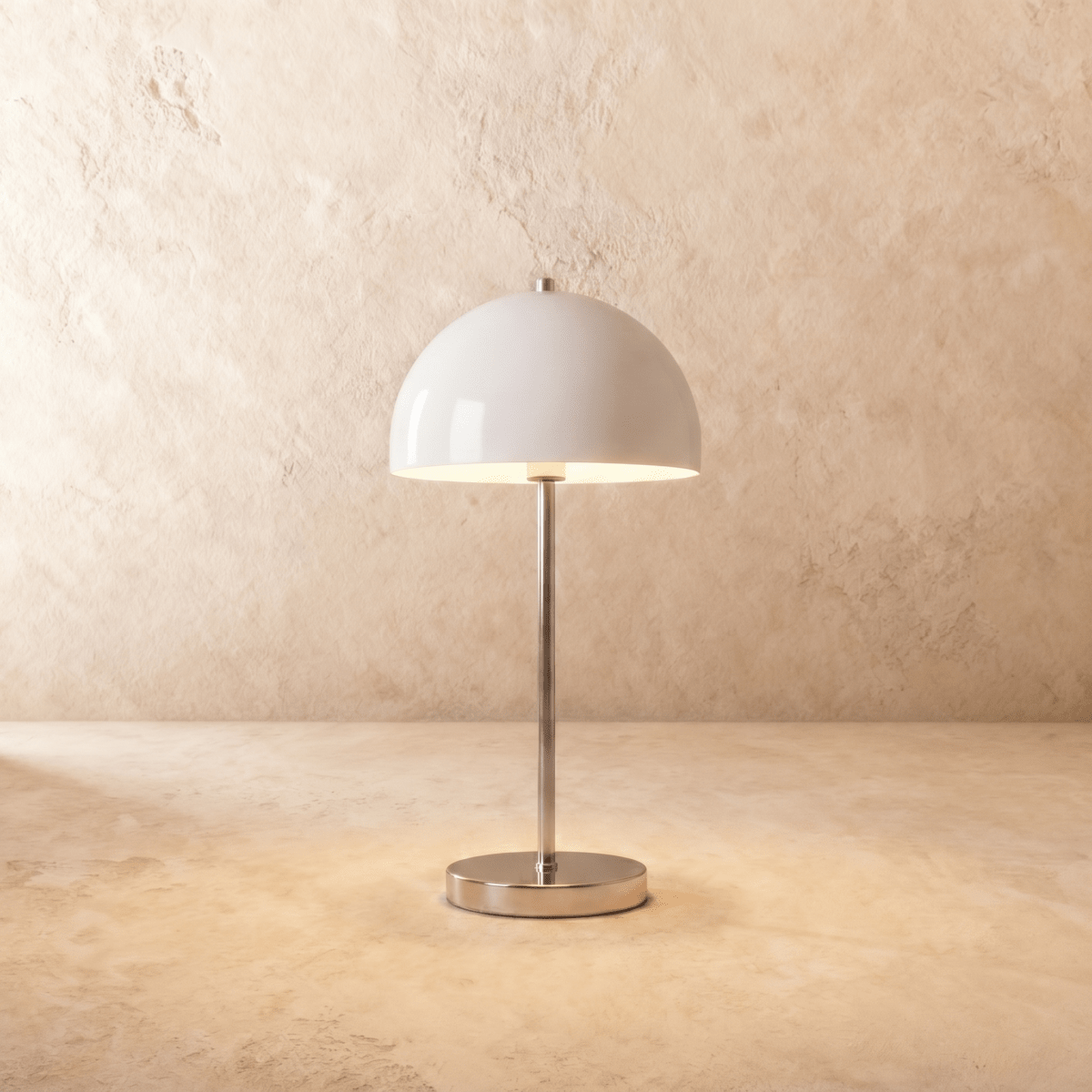 Clérachic table lamp in chrome, its glossy white dome shade set atop a slim polished stem.