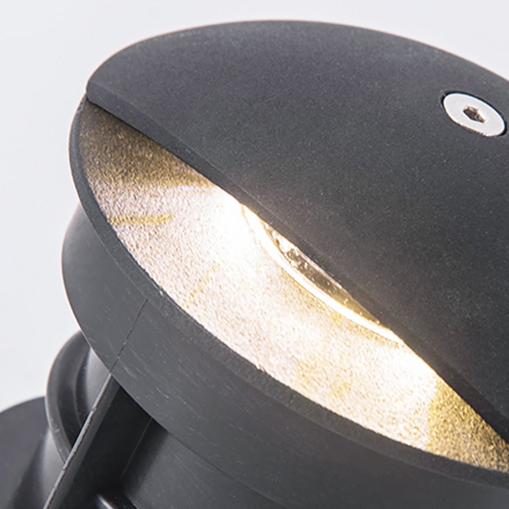 Extreme close-up of the domed cap and one lit aperture, showing the recessed lens inside.