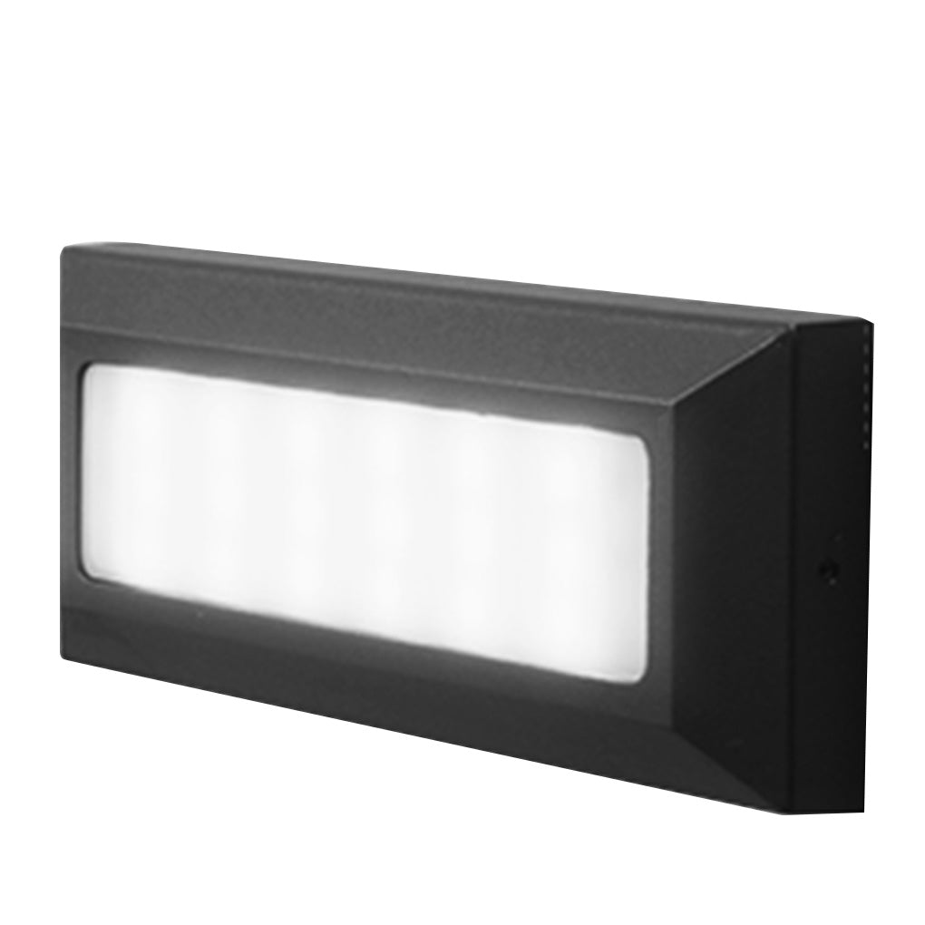 The same light lit in cool white, its lens reading bright and neutral rather than amber.