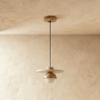 Clérachic pendant light in light wood, the flat disc and glass globe shown from a slightly different angle.