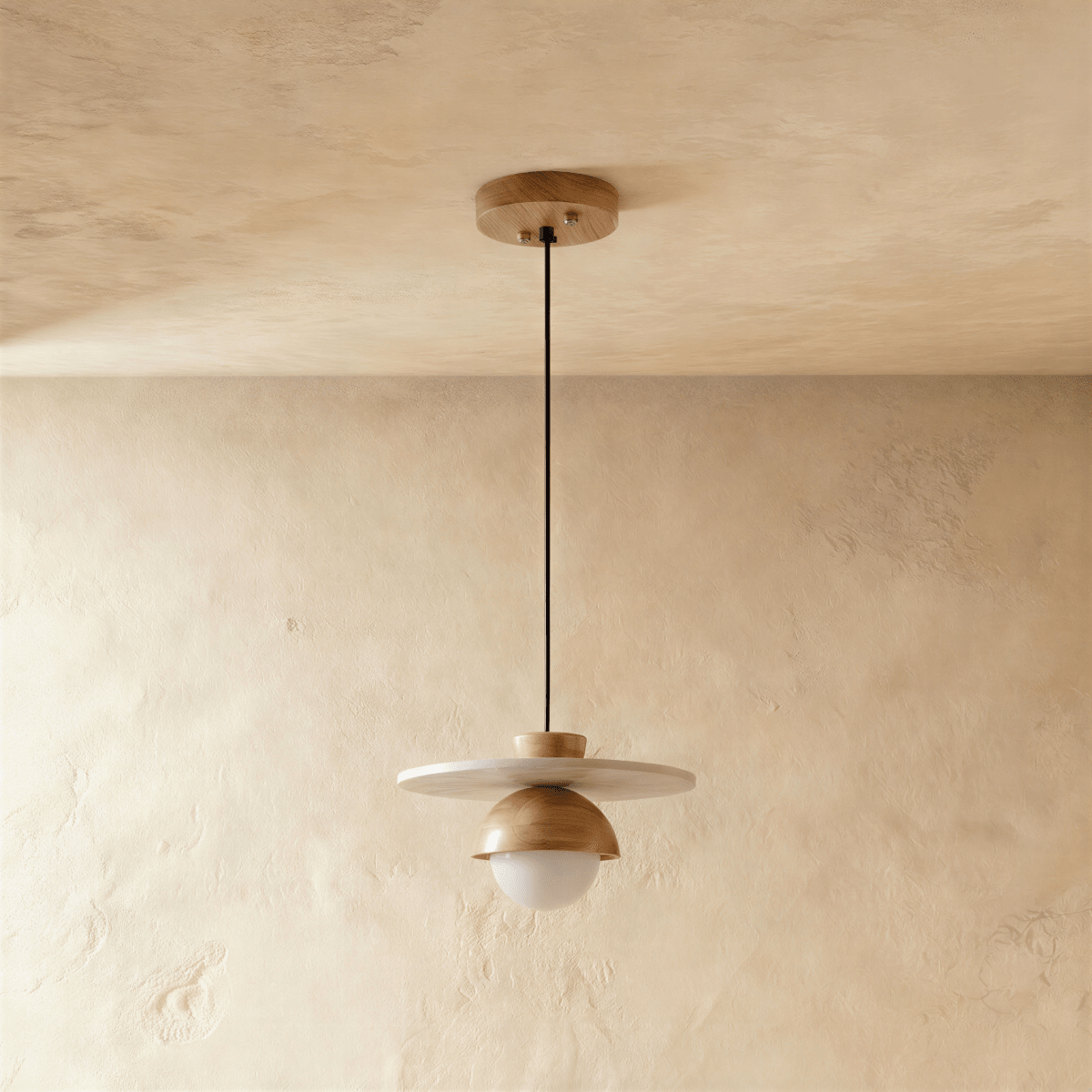Clérachic pendant light in light wood, the flat disc and glass globe shown from a slightly different angle.