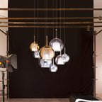 Glass globe pendant light glowing above a styled console