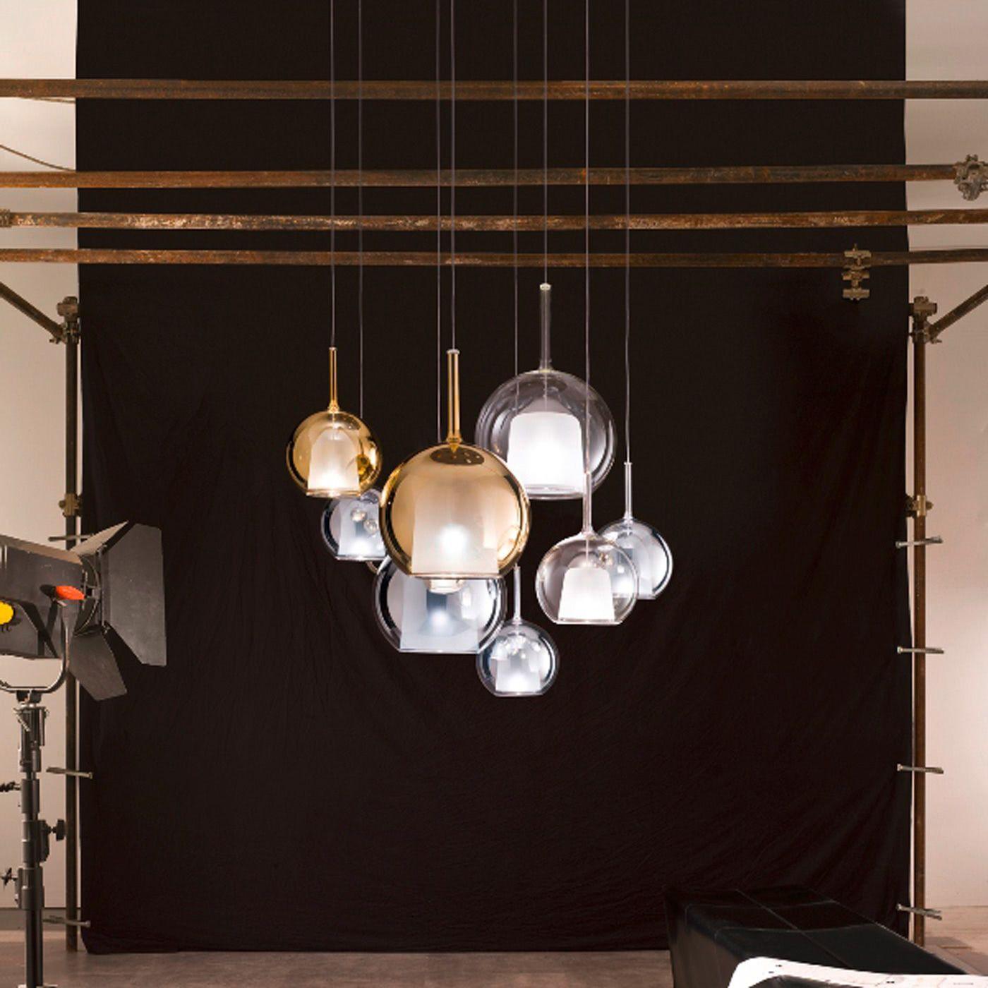 Glass globe pendant light glowing above a styled console