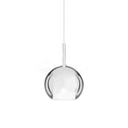 Glass globe pendant light glowing warmly in a quiet corner