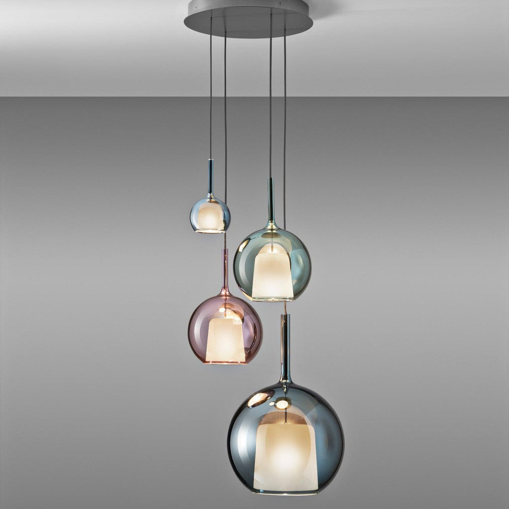 Glass globe pendant light glowing in a moody dark room