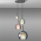 Glass globe pendant light glowing in a moody dark room
