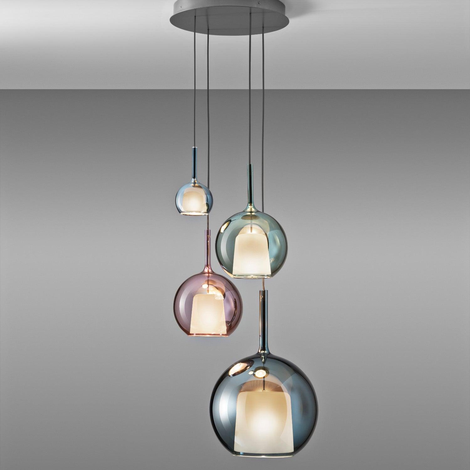 Glass globe pendant light glowing in a moody dark room