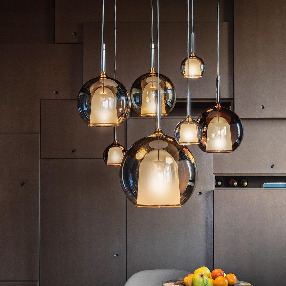Cluster of glass globe pendant lights at varied heights