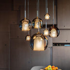 Cluster of glass globe pendant lights at varied heights
