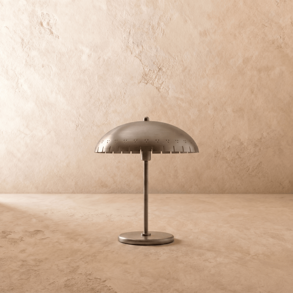 Clérachic table lamp in chrome, close view of the perforated dome shade and slim metal stem.