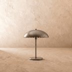 Clérachic table lamp in chrome, close view of the perforated dome shade and slim metal stem.