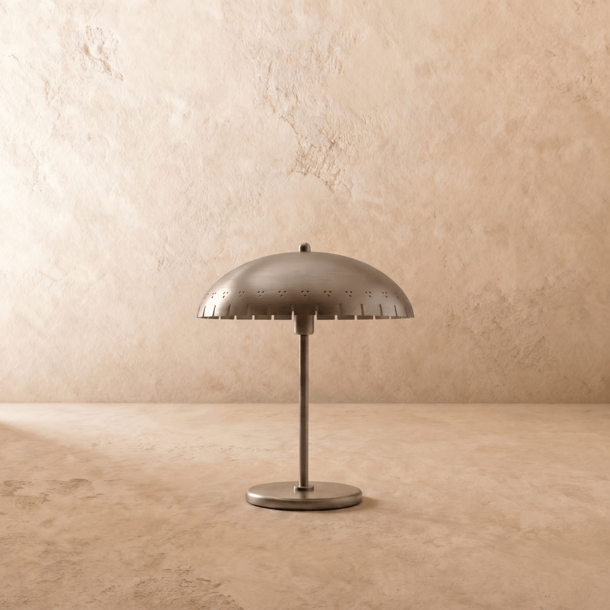 Clérachic table lamp in chrome, close view of the perforated dome shade and slim metal stem.