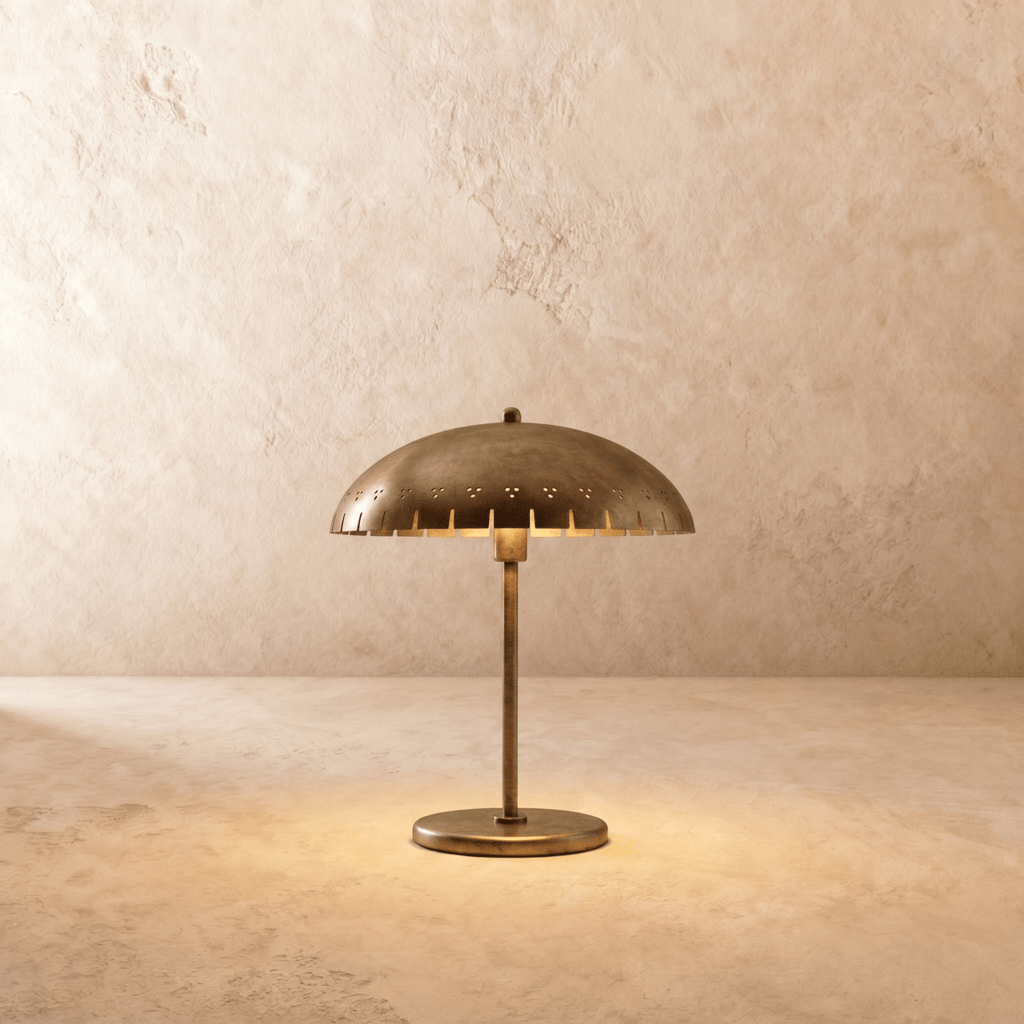 Clérachic table lamp in vintage brass with a perforated dome shade on a slender stem and round base.