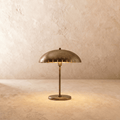 Clérachic table lamp in vintage brass with a perforated dome shade on a slender stem and round base.