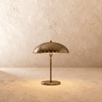 Clérachic table lamp in vintage brass with a perforated dome shade on a slender stem and round base.