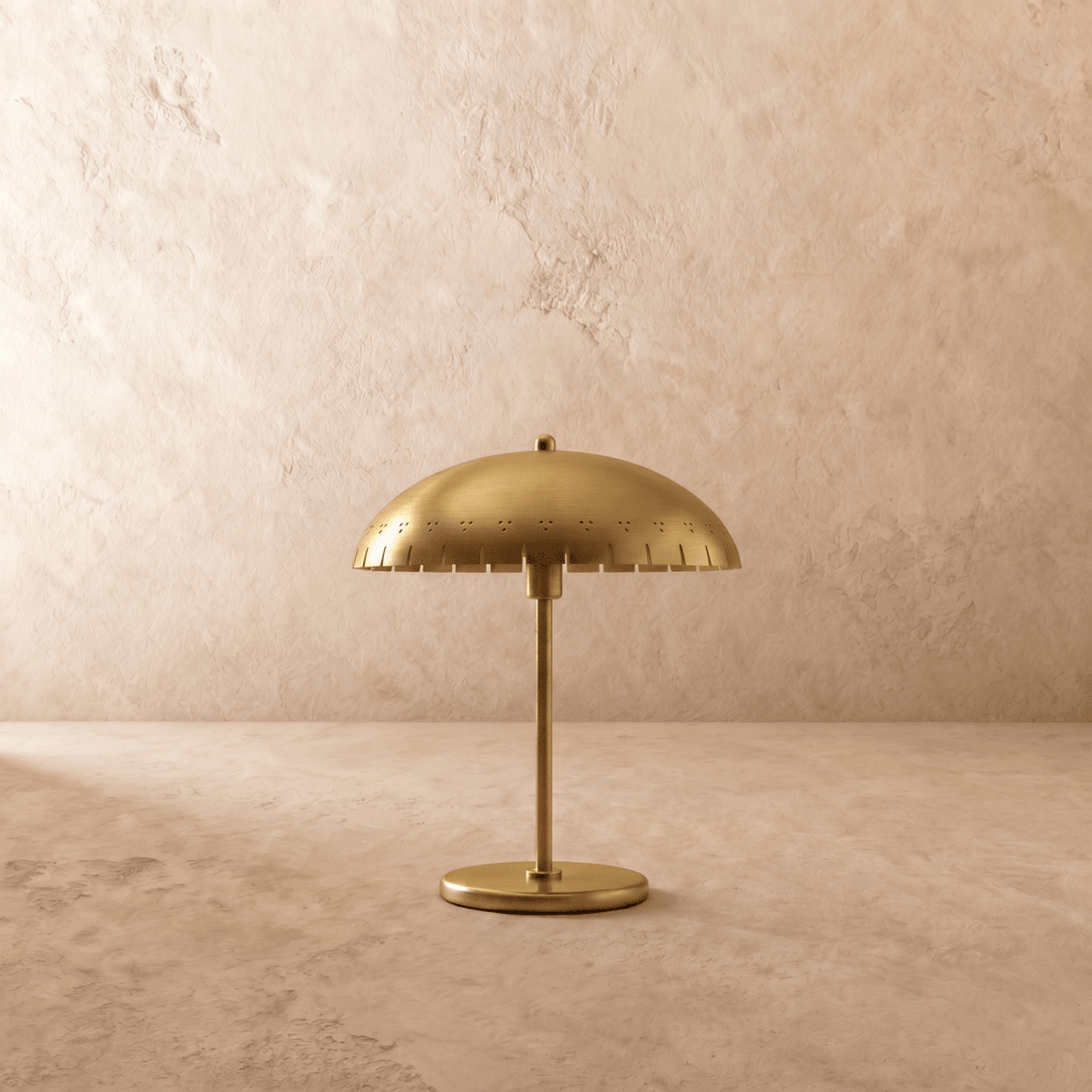 Clérachic table lamp in satin brass, front view of the perforated dome shade and round base.