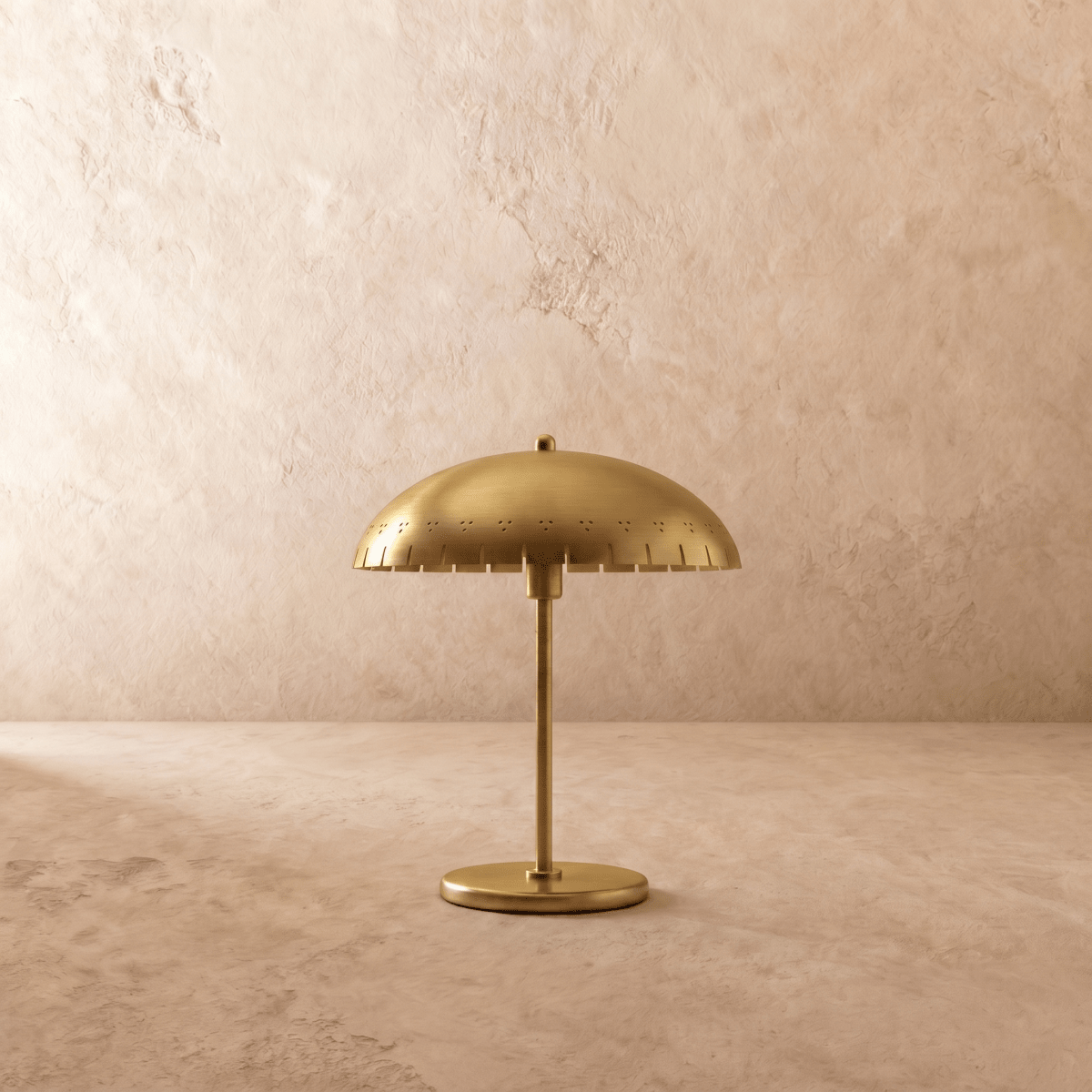 Clérachic table lamp in satin brass, front view of the perforated dome shade and round base.