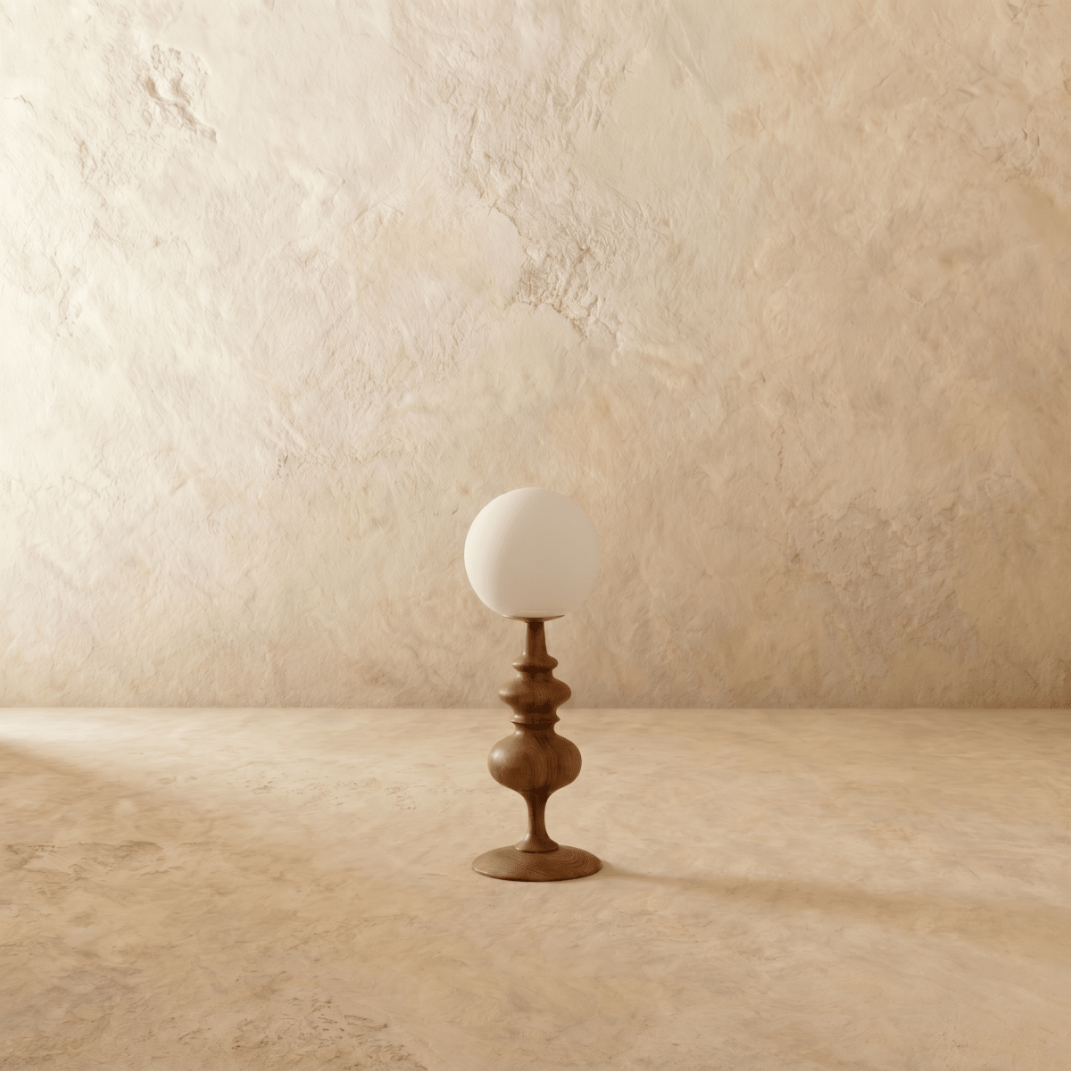 Clérachic table lamp in walnut, a closer view of the glowing globe shade and turned wood base.