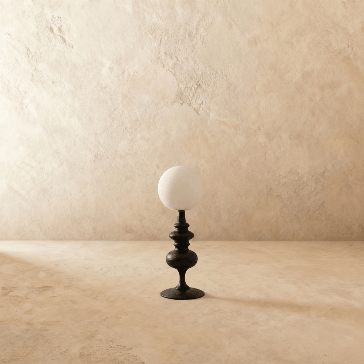 Clérachic table lamp in matte black, a turned wood-look base beneath an opal glass globe shade, unlit.