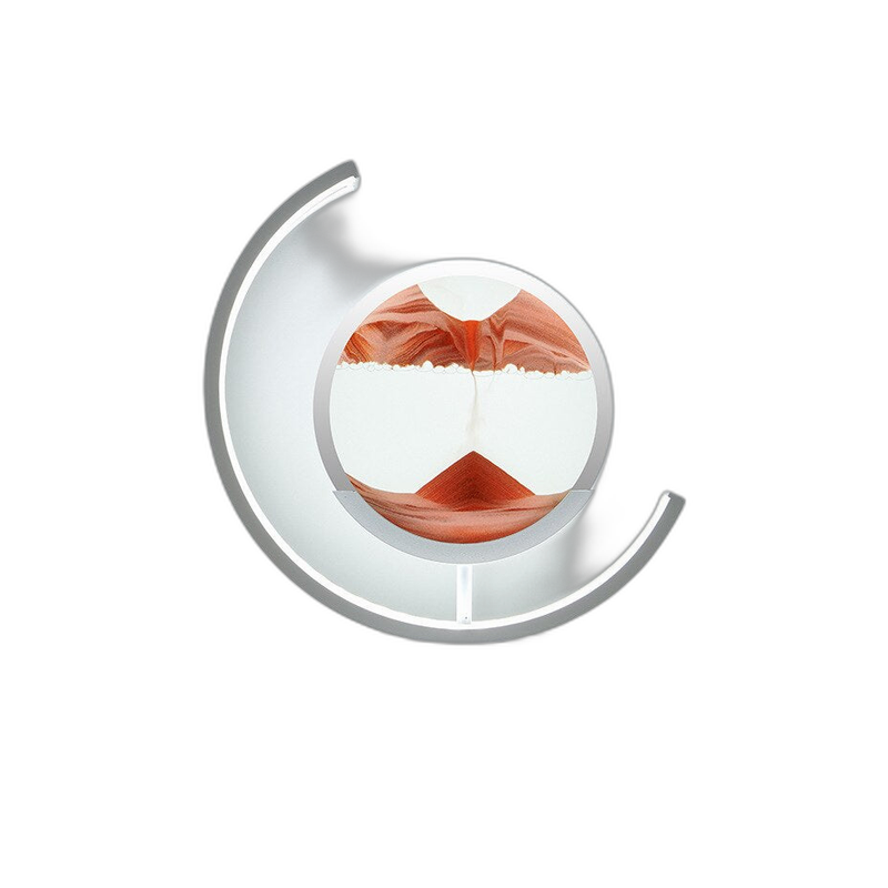 Moving sand art lamp with red sand falling into fresh dune shapes inside the glass disc