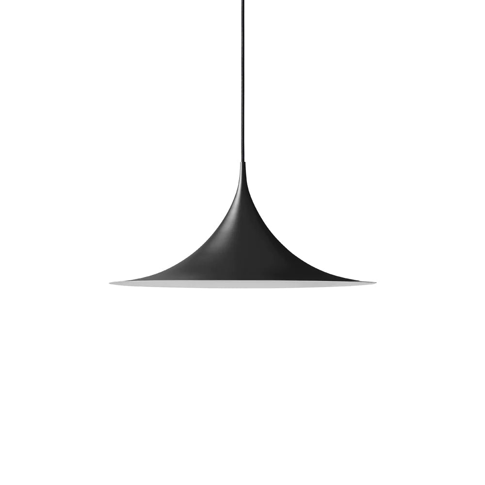 Arch-shaped pendant light hanging above a styled dining table