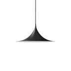 Arch-shaped pendant light hanging above a styled dining table