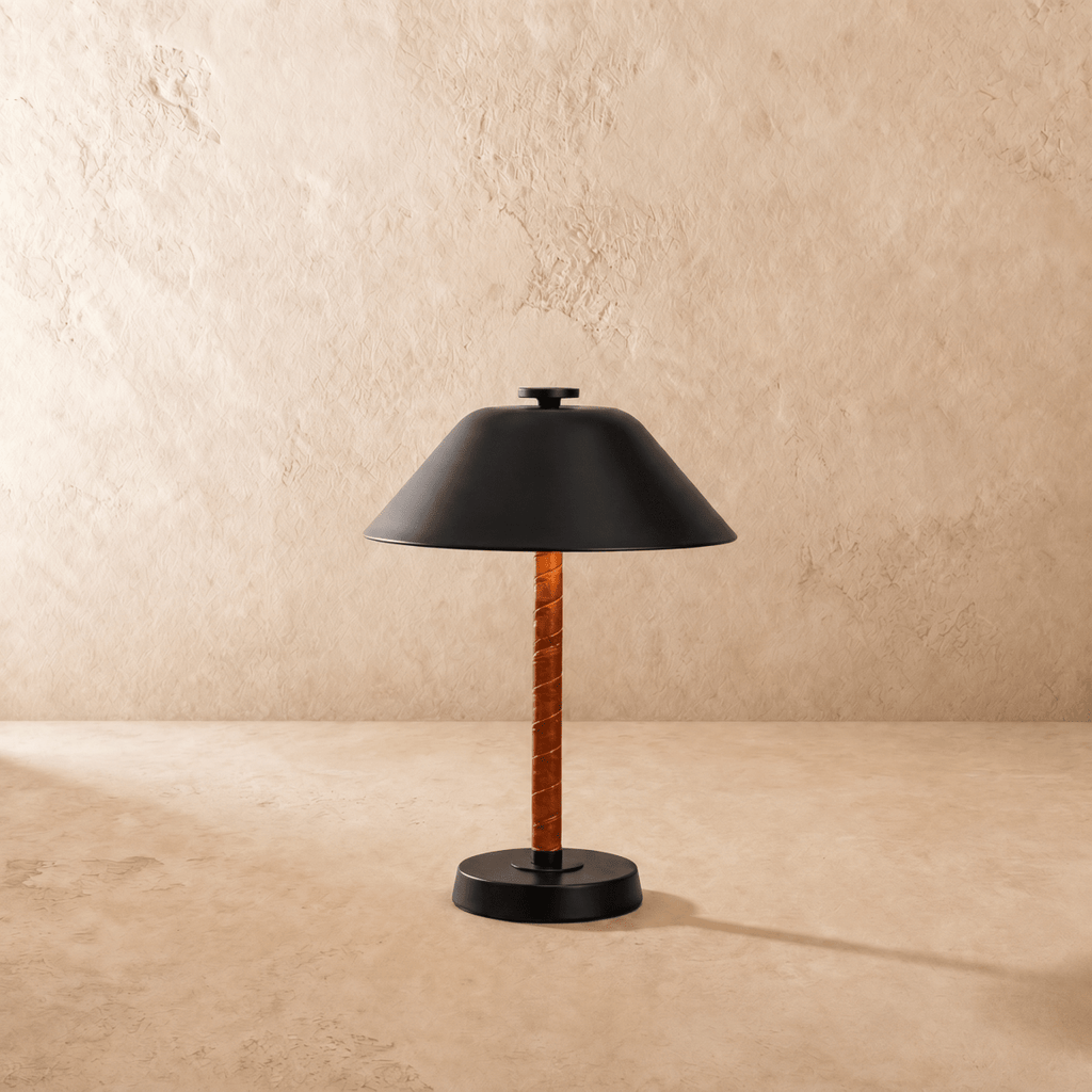 Clérachic table lamp in matte black viewed close, showing the round base and leather-wrapped stem.