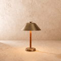 Clérachic table lamp in vintage brass, a cone metal shade over a cognac leather-wrapped stem.