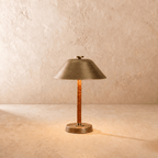 Clérachic table lamp in vintage brass, a cone metal shade over a cognac leather-wrapped stem.