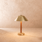 Clérachic table lamp in brushed brass, the cone metal shade set above a leather-wrapped stem.