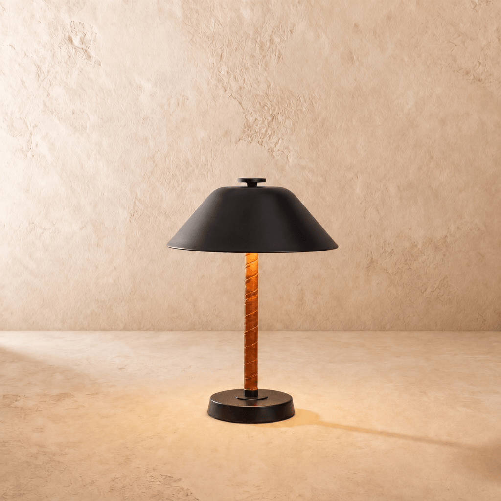 Clérachic table lamp in matte black, the cone metal shade set above a leather-wrapped stem.