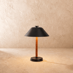 Clérachic table lamp in matte black, the cone metal shade set above a leather-wrapped stem.