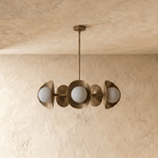 Clérachic chandelier in vintage brass, the disc shades and glass globes viewed from a slightly different angle.
