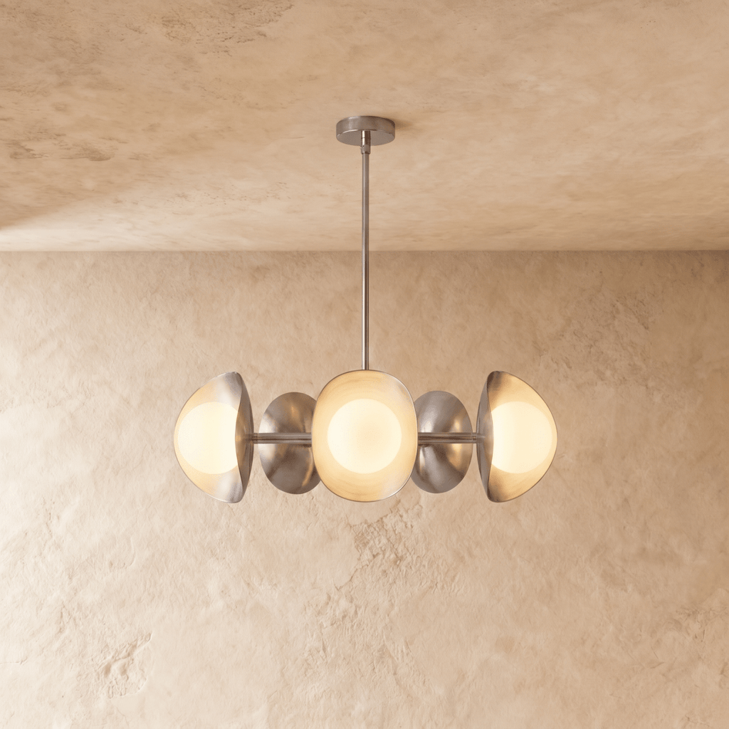 Clérachic chandelier in a bright chrome finish, its row of overlapping discs and opal globes below a ceiling.