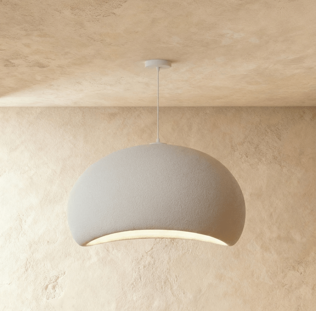 Clérachic Shibui pendant light in the Cloud form, its muted grey-white shell lit only along the crescent underneath.