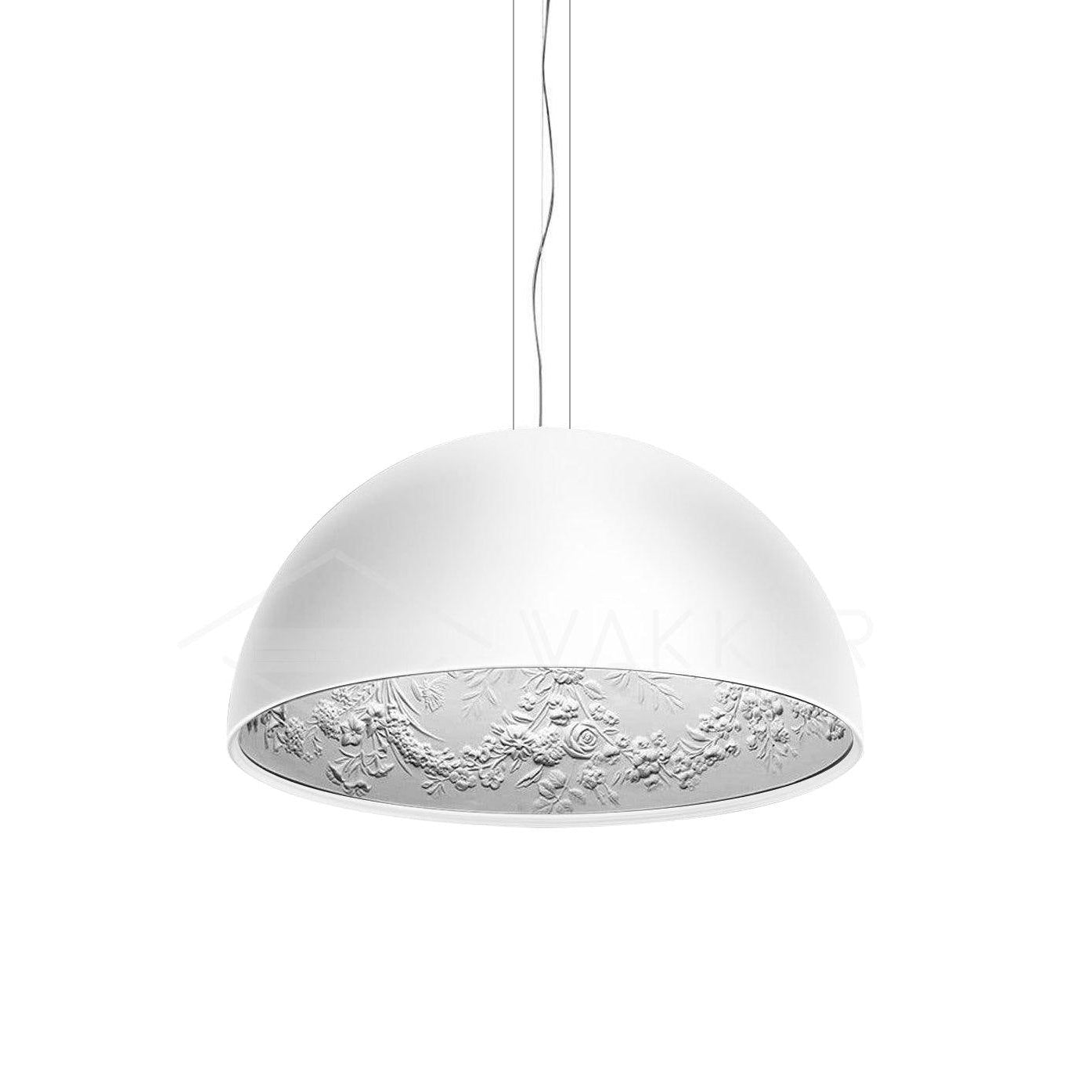 Hemisphere pendant glowing warmly above a dining setting