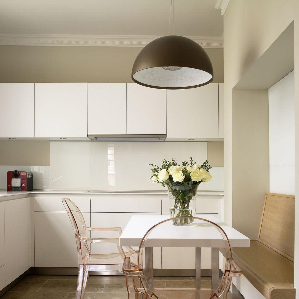Hemisphere pendant suspended above a dining table at dusk