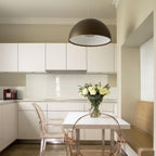 Hemisphere pendant suspended above a dining table at dusk