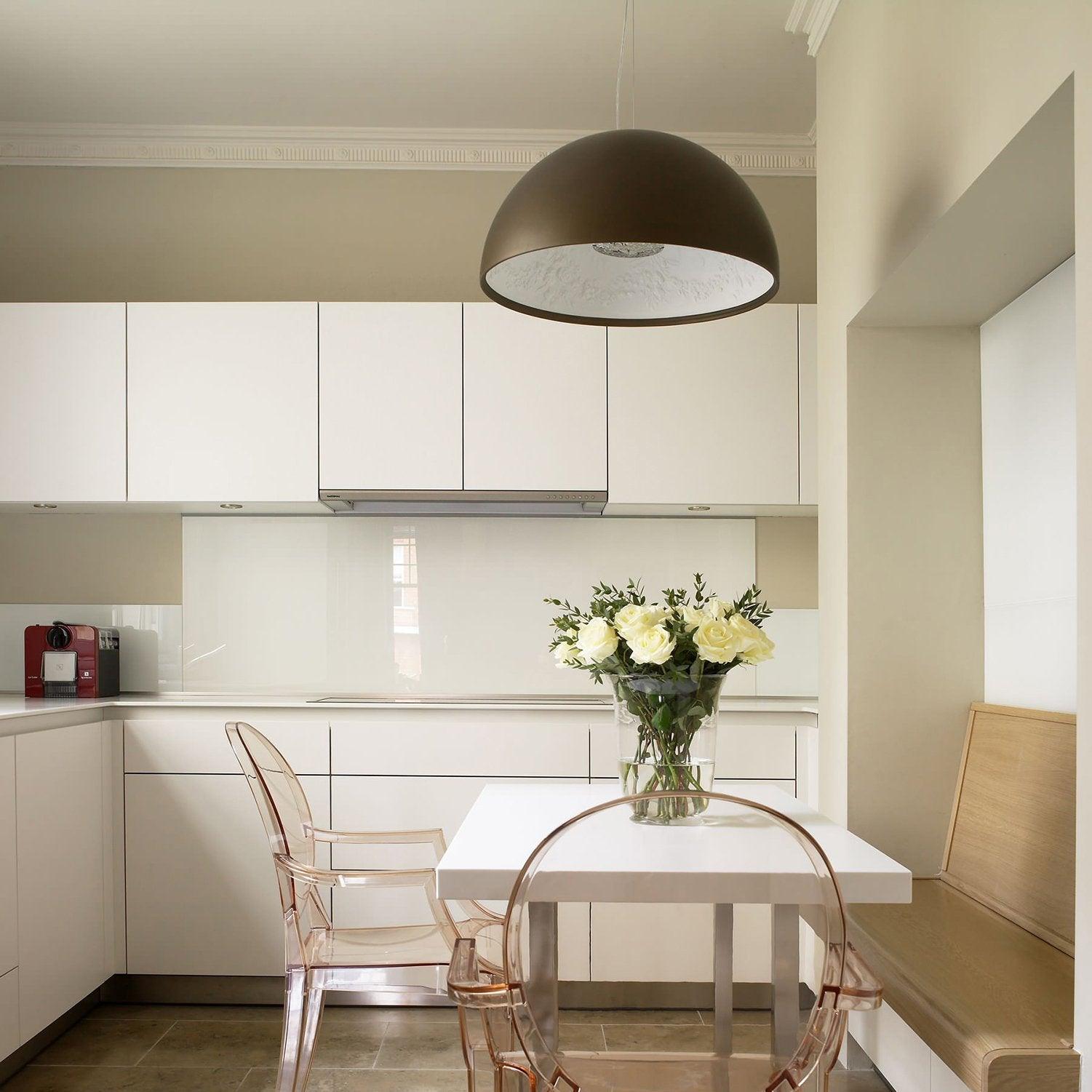 Hemisphere pendant suspended above a dining table at dusk