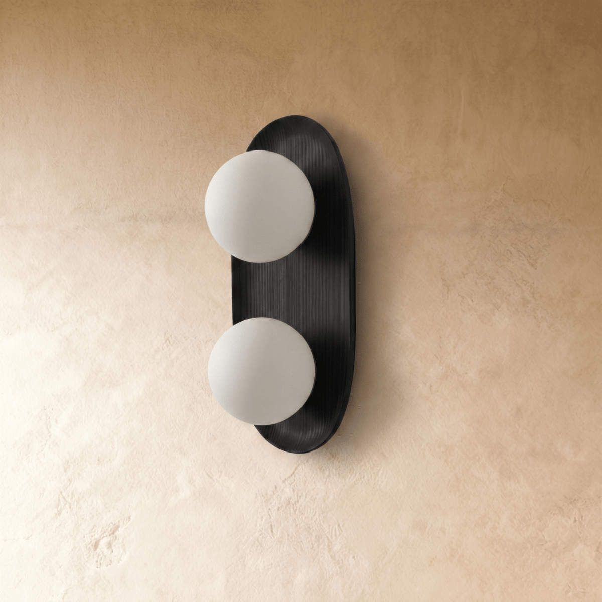 Close view of the Clérachic wall light where a globe meets the backplate