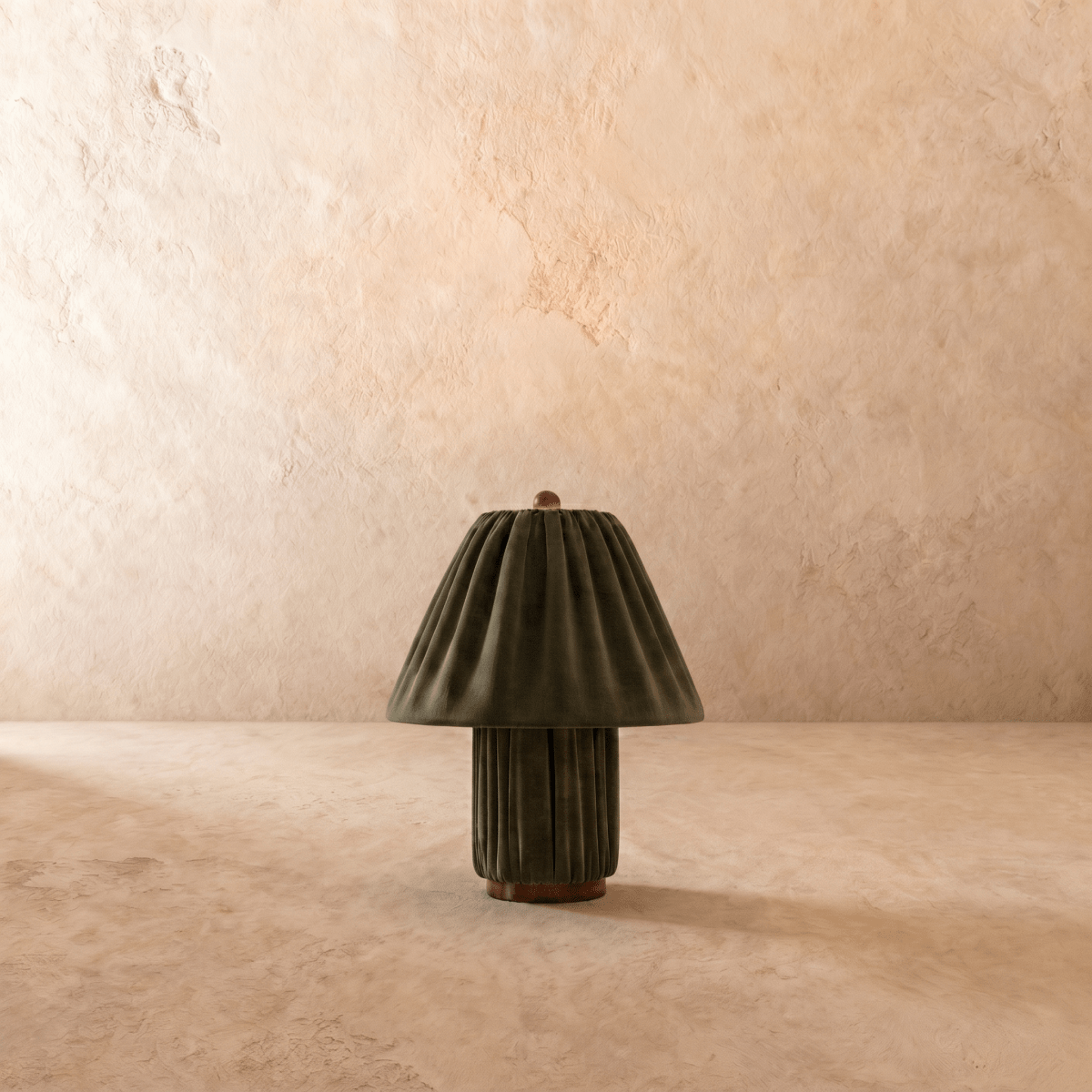 Clérachic table lamp in pleated olive green fabric glowing warm, shown from a slightly different angle.
