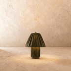 Clérachic table lamp in a pleated olive green fabric shade over a matching fluted column base.