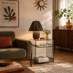 Clérachic table lamp in pleated olive green fabric glowing beside a sofa beneath a framed art print.