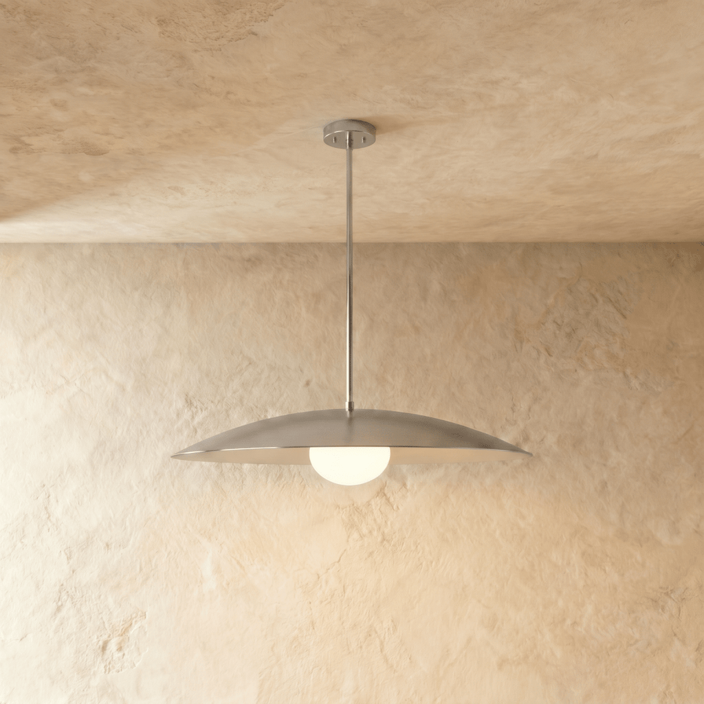 Clérachic pendant light in chrome, its saucer shade and opal diffuser hanging from a slender rod.