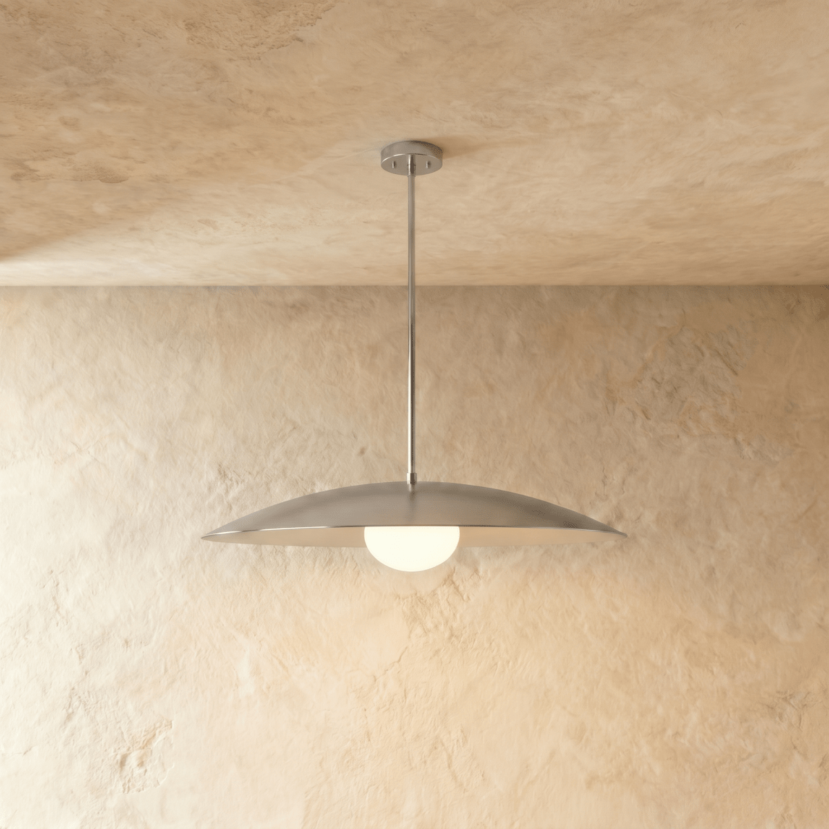 Clérachic pendant light in chrome, its saucer shade and opal diffuser hanging from a slender rod.