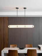 Linear pendant light shown over a dining table