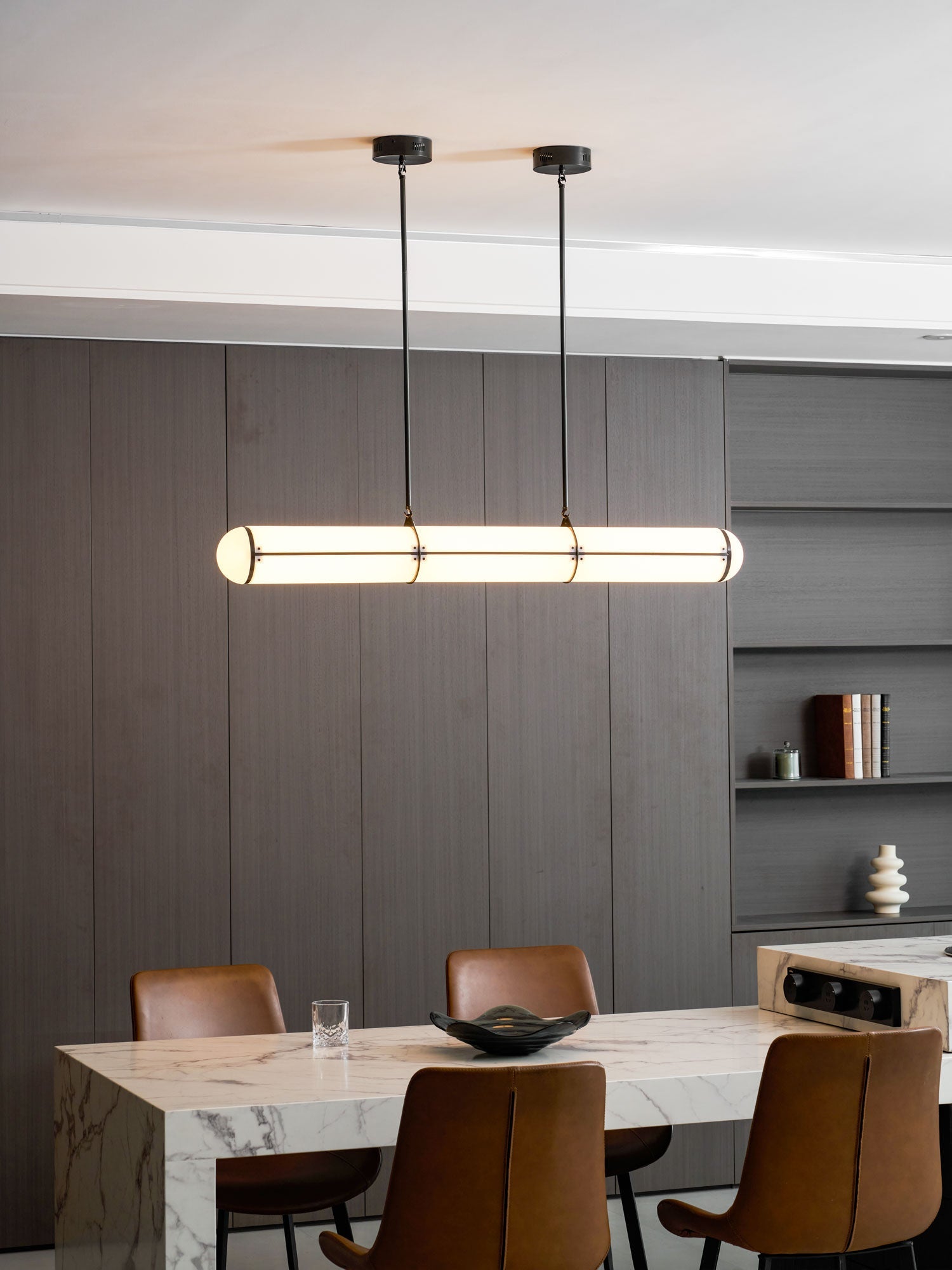 Linear pendant light glowing in an architectural interior