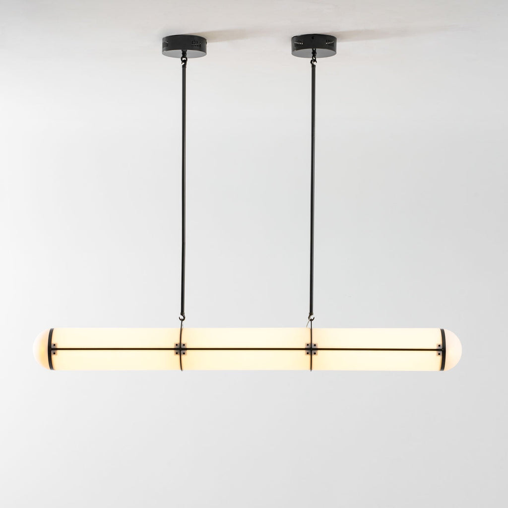 Linear pendant light shown lit in a styled interior