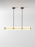 Linear pendant light suspended above a table